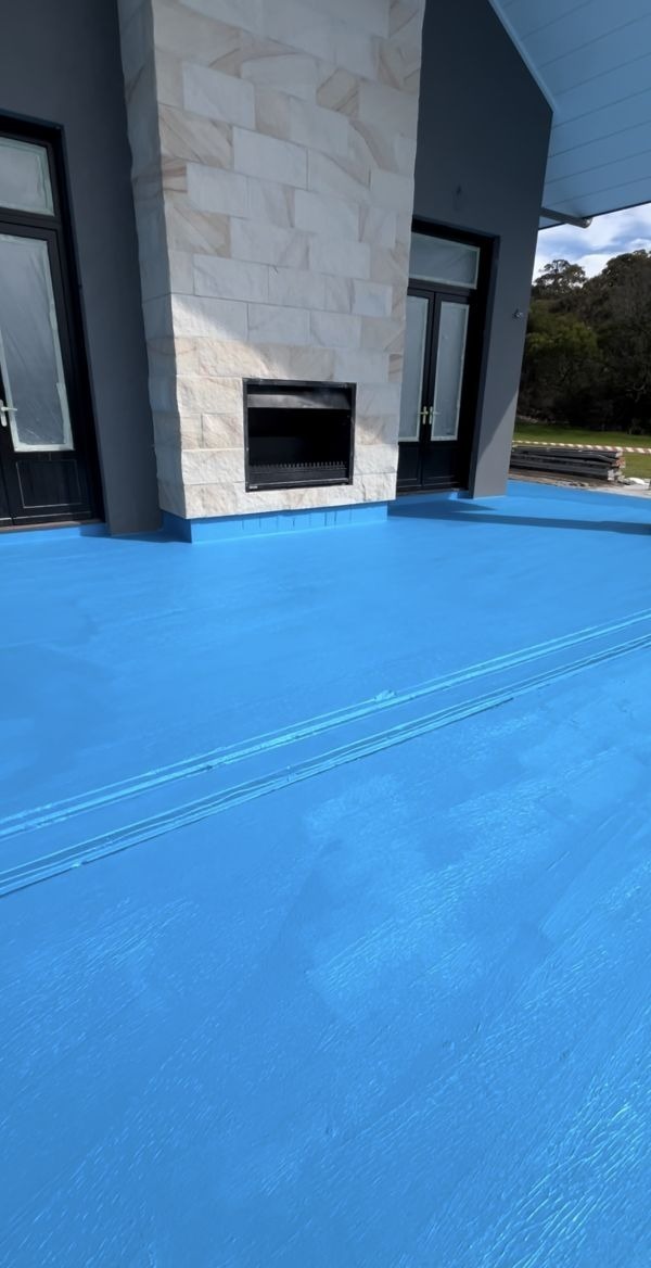 Alfresco deck membrane with stone fireplace